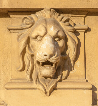Lion head relief carving on building wall