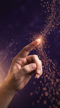 Finger touching a stream of orange binary code on a dark purple abstract background, symbolizing data, technology and information flow