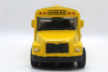 Front view of yellow school toy bus isolated on white background back to school concept  © Yousra Saleh 
