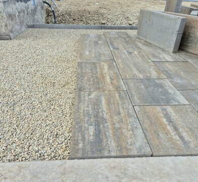 Modern interlocking paving stones laid on a crushed stone gravel bed during landscaping.