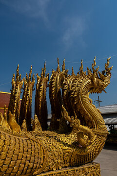 Golden Naga sculptures at Wat Sri Panton in Nan Province, Thailand, showcasing ornate Buddhist architecture, sacred craftsmanship and Northern Lanna heritage
