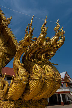 Golden Naga sculptures at Wat Sri Panton in Nan Province, Thailand, showcasing ornate Buddhist architecture, sacred craftsmanship and Northern Lanna heritage