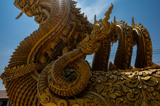 Golden Naga sculptures at Wat Sri Panton in Nan Province, Thailand, showcasing ornate Buddhist architecture, sacred craftsmanship and Northern Lanna heritage