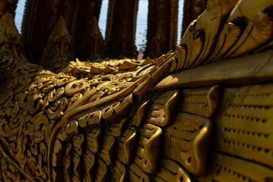 Golden Naga sculptures at Wat Sri Panton in Nan Province, Thailand, showcasing ornate Buddhist architecture, sacred craftsmanship and Northern Lanna heritage