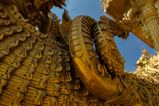 Golden Naga sculptures at Wat Sri Panton in Nan Province, Thailand, showcasing ornate Buddhist architecture, sacred craftsmanship and Northern Lanna heritage