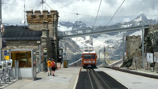Gornergrat Railway Train Arriving at Mountain Station, Zermatt, Switzerland. Cinematic parallax view of the cogwheel train arriving at Gornergrat Station.