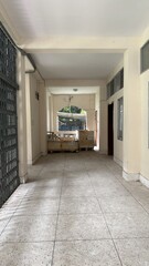 Fototapeta premium A long empty corridor with a gate and stacked wooden boxes