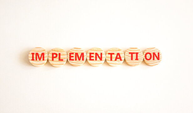 Implementation word symbol. Concept word Implementation on beautiful wooden circles. Beautiful white background. Business implementation word concept. Copy space.