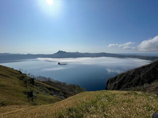 Lake Mashu with drifting sea of clouds in Hokkaido, Japan © Hiro