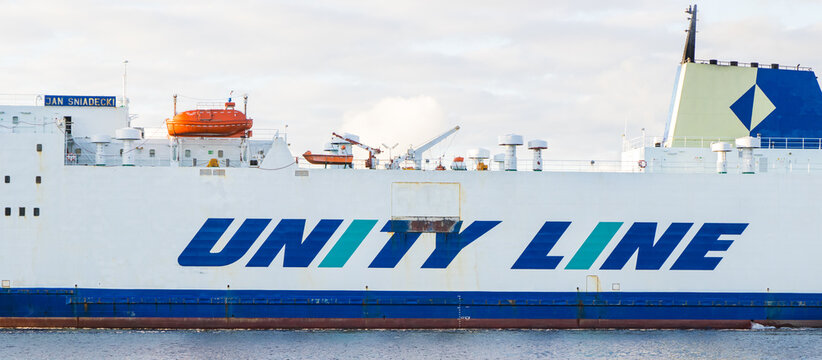 Swinoujscie, West Pomeranian - Poland - July 14, 2022: Inscription Unity Line on Jan Sniadecki ferry leaving port in Swinoujscie. Transport passengers and cars
