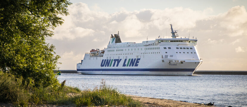 Swinoujscie, West Pomeranian - Poland - July 15, 2022: Unity Line Polonia ferry entering to port in Swinoujscie at sunrise. Transport passengers and cars