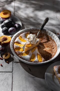 Plum pie with mascarpone cream and fresh peach slices