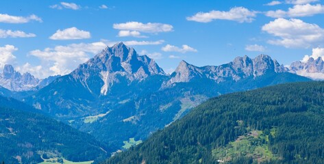 Naklejka premium Majestic scenery of rough mountain ridge near grassy hills 