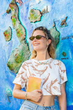 Tourist woman with Galapagos Islands map in Ecuador