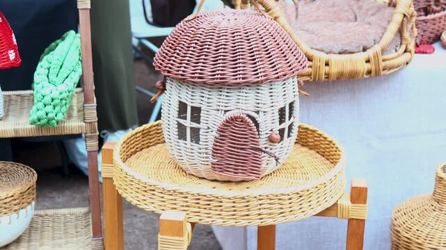 A house sits on top of a wicker basket