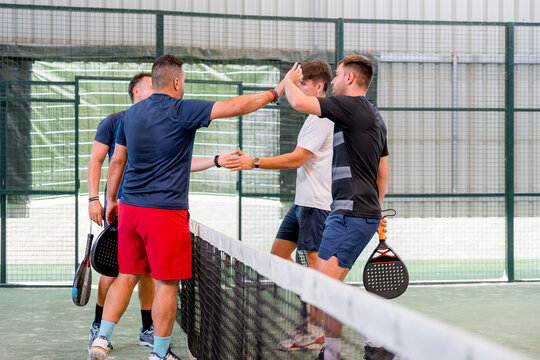 Padel tournament players celebrate victory at indoor court