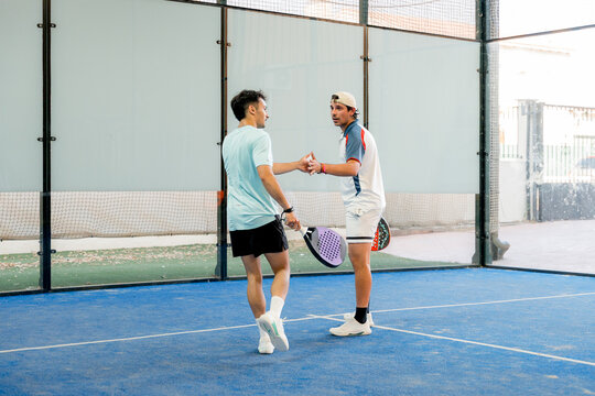 Padel players celebrate point during indoor tournament match