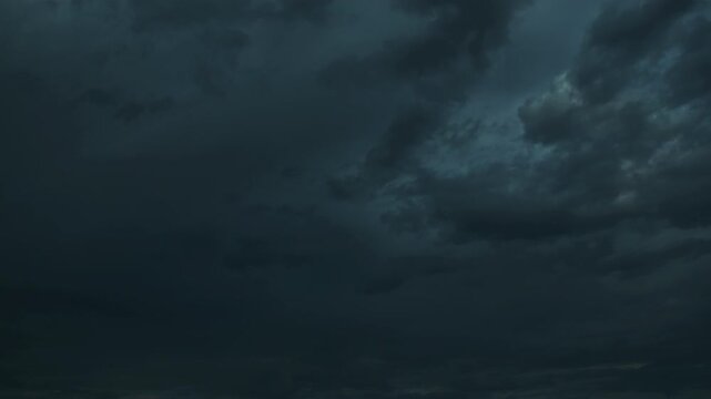 Night. Clouds clearing. Sunrise.  Sky clearing. Time-lapse.
From a dark, impenetrable sky heavy with clouds to a clear, cloudless dawn