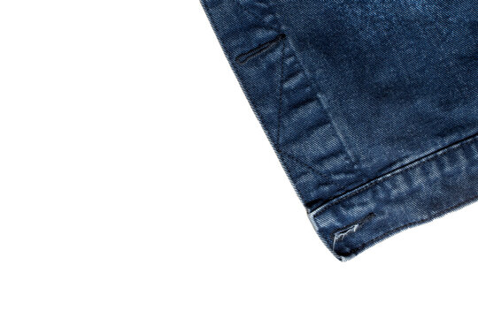 Dark blue denim jacket hem detail with buttonhole isolated on white background, jeans fabric texture corner layout.