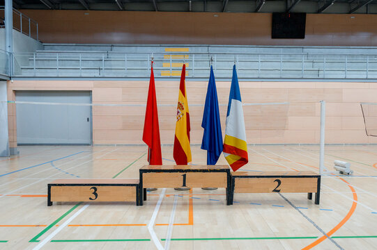 Badminton tournament podium with flags in indoor sports hall