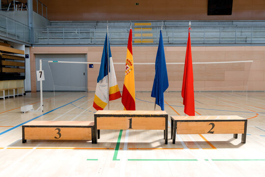 Badminton tournament podium with national flags in sports hall