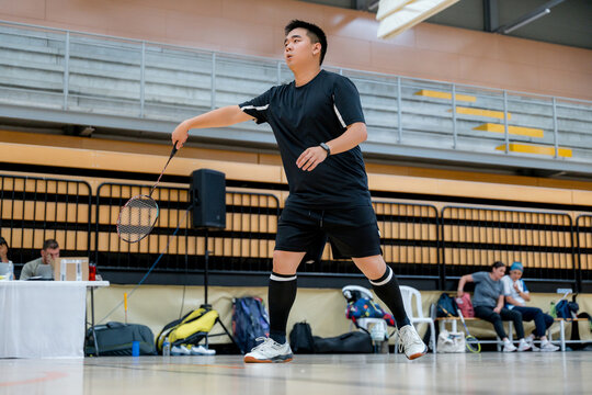 Badminton tournament player prepares for a forehand return