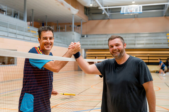 Badminton tournament players celebrate friendly match victory