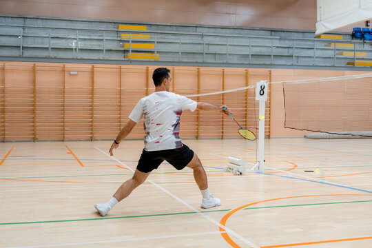 Badminton player compete in indoor tournament match