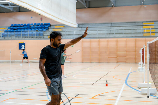 Badminton player compete in indoor tournament match