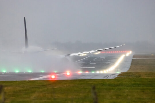 Airplane taking off in heavy rain on wet runway