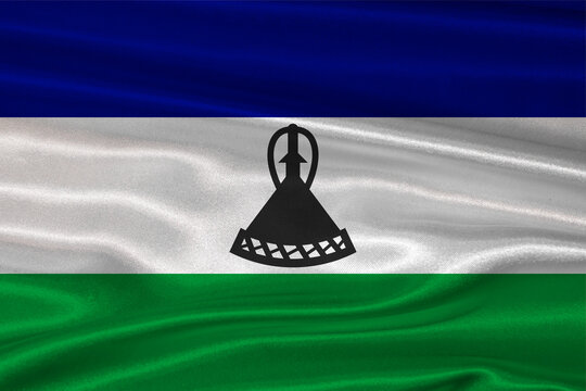 Basotho flag textured with fabric background. Flag of Lesotho with a soft fabric texture