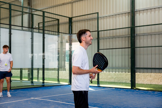 Padel doubles match with players on indoor court