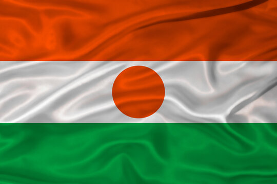 Flag of Niger with a soft fabric texture. Nigerien flag textured with fabric background