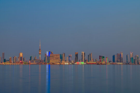 Kuwait City Skyline at Blue Hour Reflected in the Arabian Gulf Waters at Dusk. Kuwait City skyline view.