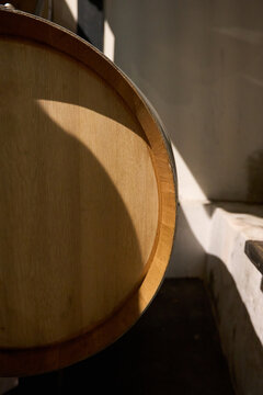 Oak wine barrel in a sunlit traditional cellar