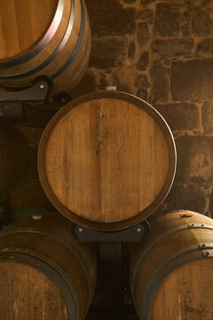 Wooden wine barrel in a rustic stone cellar