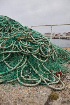 Tangled fishing net and rope on a weathered harbor dock