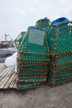 Stacked fishing trap at a working harbor dock