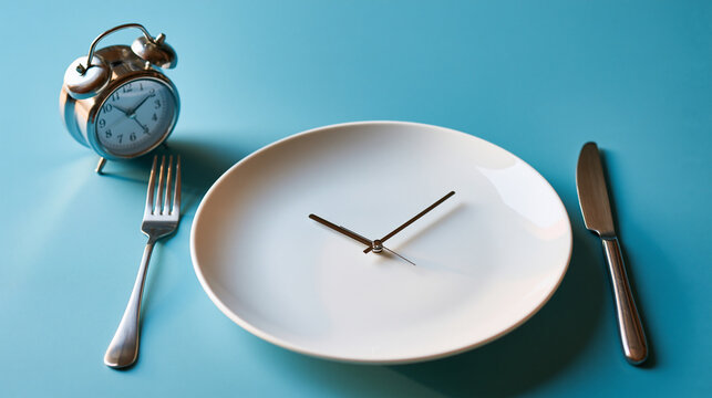 intermittent fasting concept with an empty white plate, clock and cutlery displayed on a bright pastel blue background, nutrition timing concept, bright, with copy space
