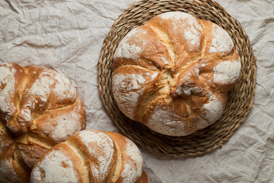 Rustic artisan bread loaf on woven rattan base