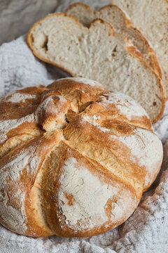 Rustic artisan bread loaf with sliced homemade bread