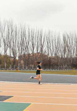 Female runner on outdoor track during athletic training