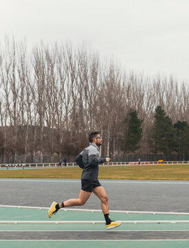 Male runner training on outdoor athletics track