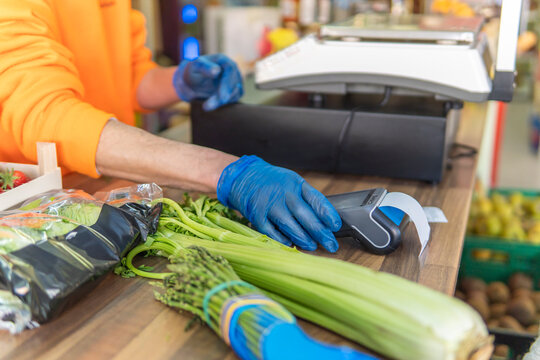 Grocery worker process contactless payment for fresh produce