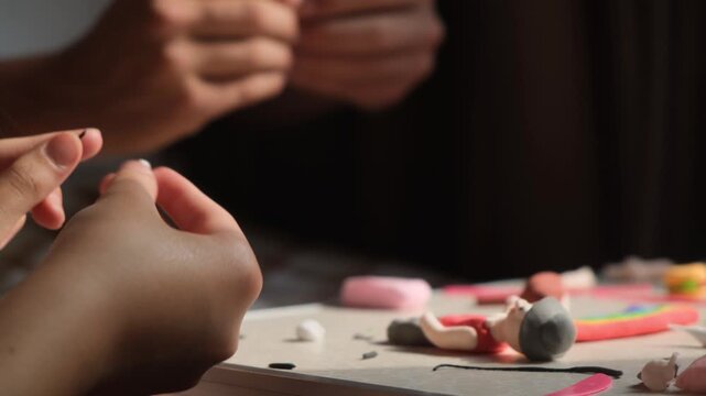 Close up of children hands carefully shaping colorful air dry clay figures. Soft sunlight illuminates their hands, creative modeling, fine motor skills and clay crafts