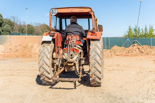 Man operate tractor during field work in countryside