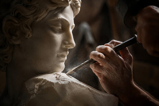 A sculptor's chisel poised for the final strike on a marble statue, dust in air.