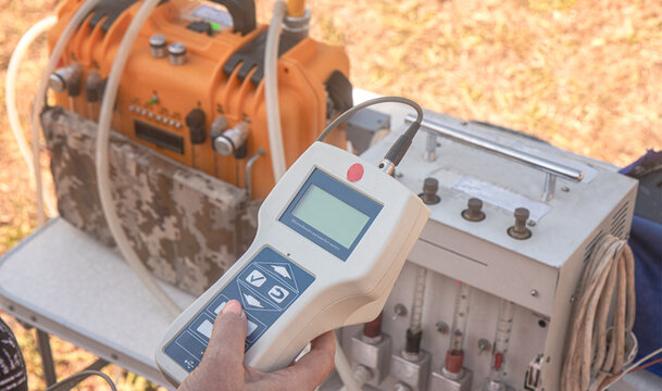 Technician Operating Portable Air Quality Analyzer Control Remote