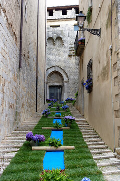 Floral art installation on historic Girona alley staircase