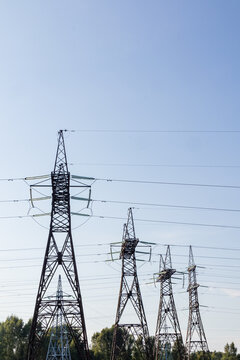 Power transmission tower network beneath clear blue sky